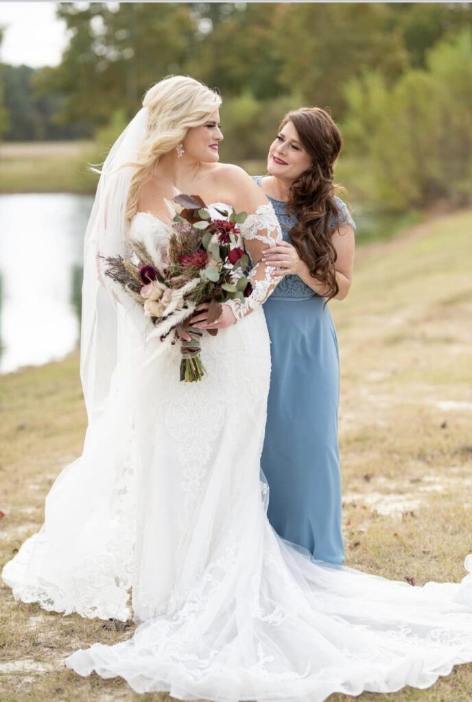 bride with mother holding flower bouquet
