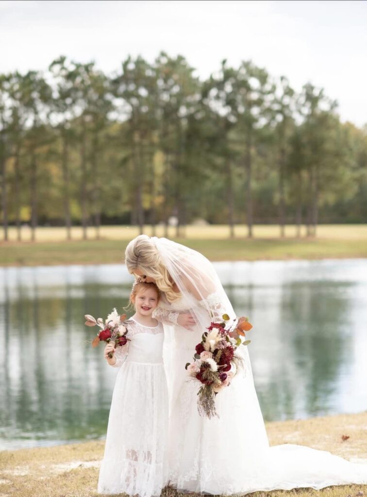 bride with daughter holding floral bouquets